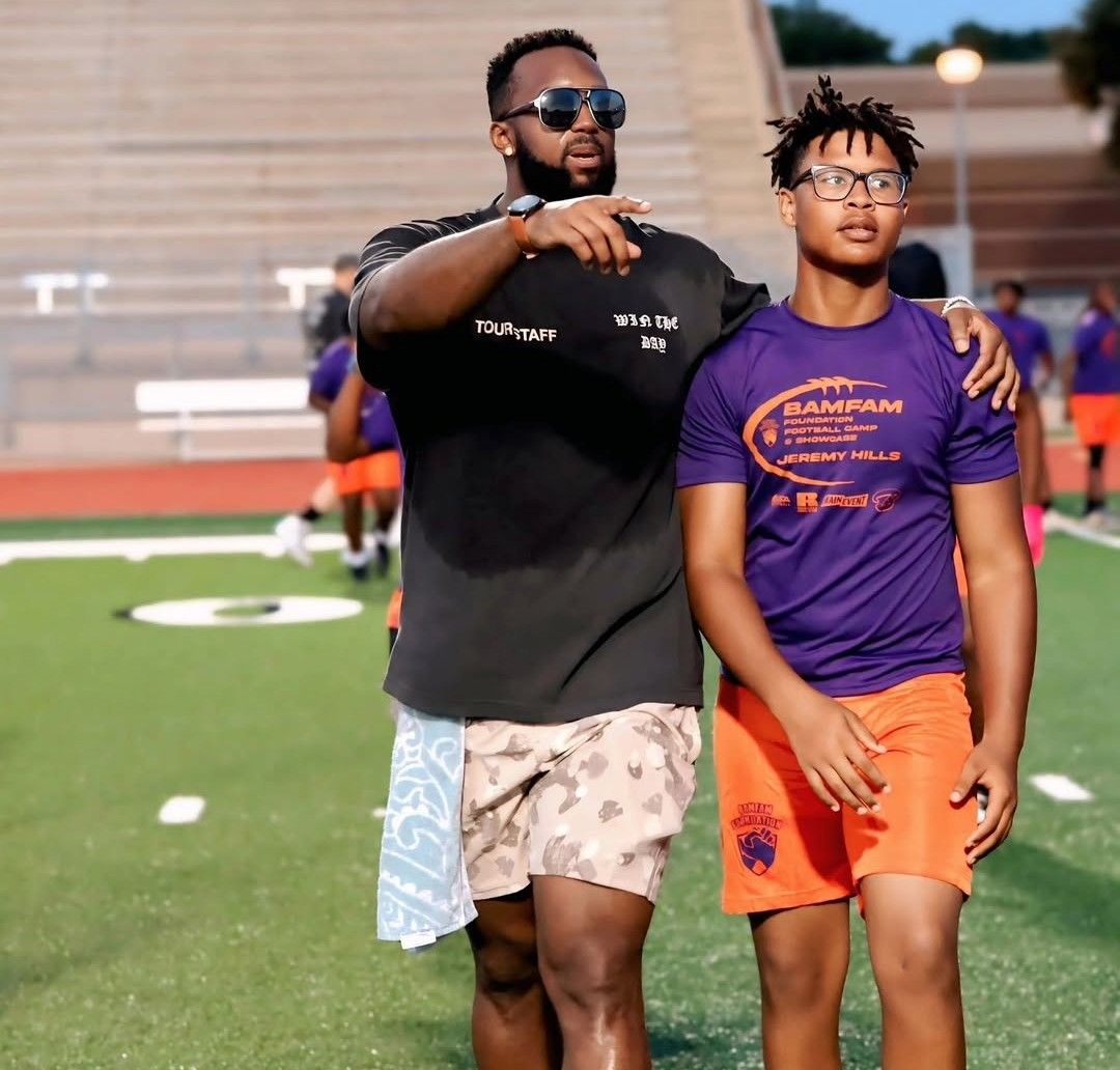 Tony Hills volunteering with a young participant at the J Hills and Friends Football Camp
