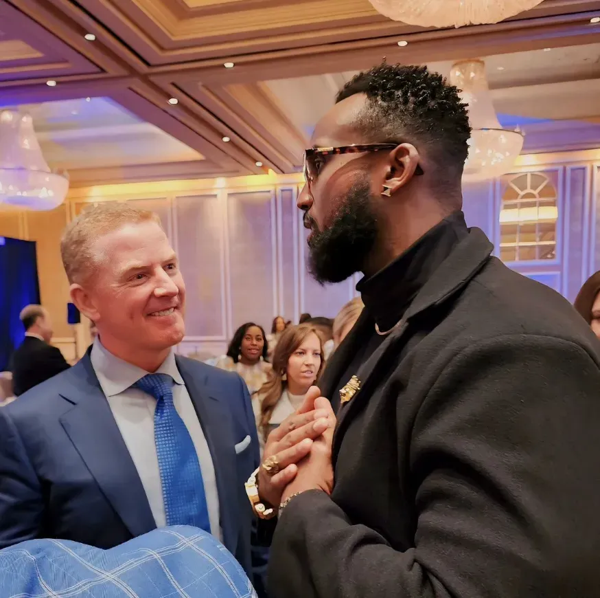 Tony Hills speaking with Jason Garrett at an event